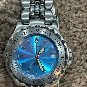Fossil Blue women’s watch. Iridescent blue face with date.